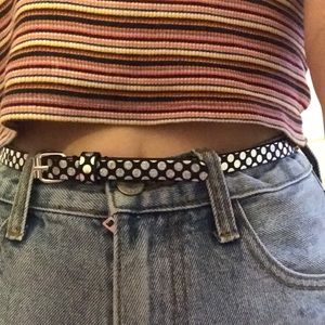 A black and silver iridescent polka dot belt.